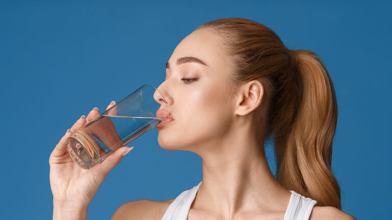 Una mujer tomando agua.